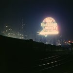 Illinois Central Railroad freight cars in the South Water Street freight terminal, Chicago, Illinois, with a neon Pabst Blue Ribbon sign in the background